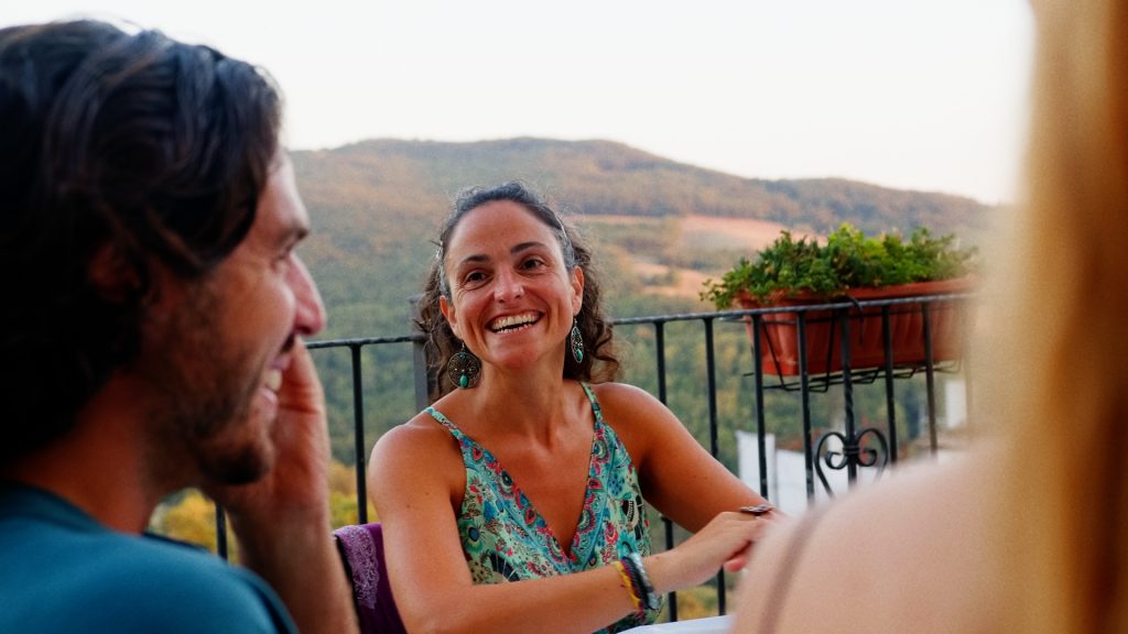 Liz and friends enjoying an aperitivo at a bar in Roseto that has mountain views